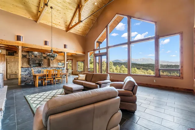 a living room with furniture and a floor to ceiling window