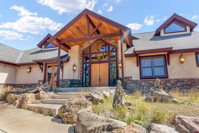 a view of a house with large windows and a table