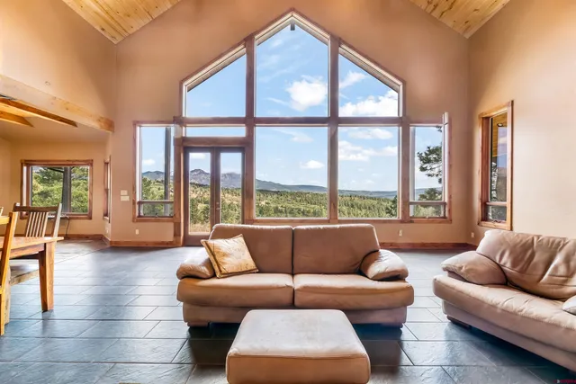 a living room with furniture and large windows