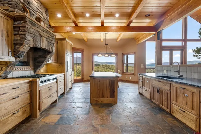 a large kitchen with cabinets and wooden floors