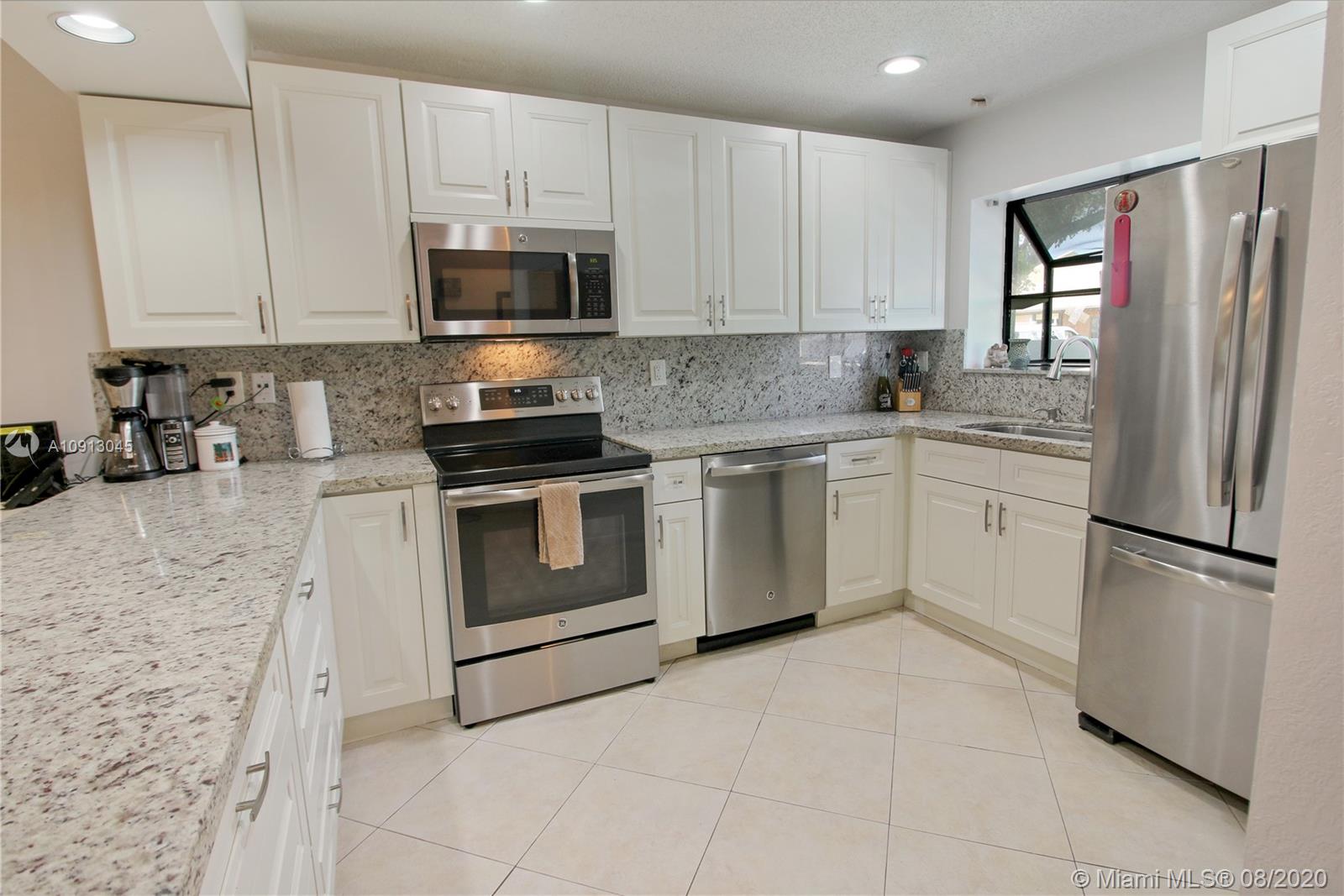 739 Banks Road Margate, FL 33063 - Photo 1 of 21 a kitchen with stainless steel appliances granite countertop a stove a refrigerator and a microwave