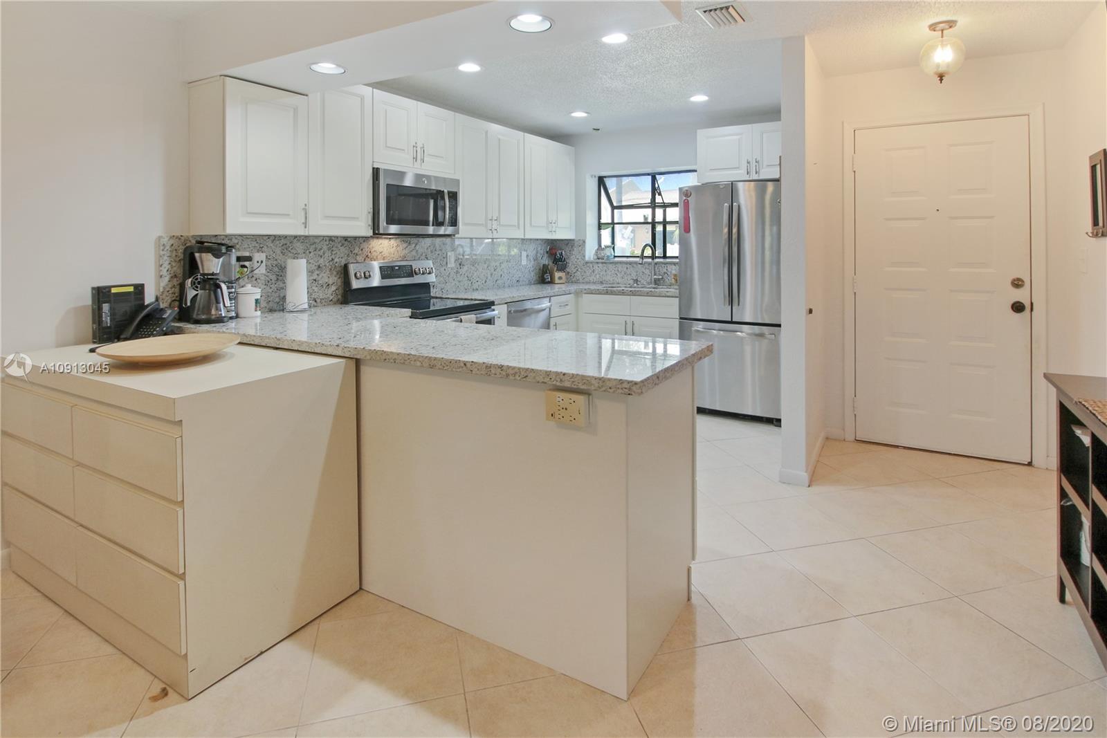 739 Banks Road Margate, FL 33063 - Photo 2 of 21 a kitchen with stainless steel appliances granite countertop a refrigerator sink and cabinets