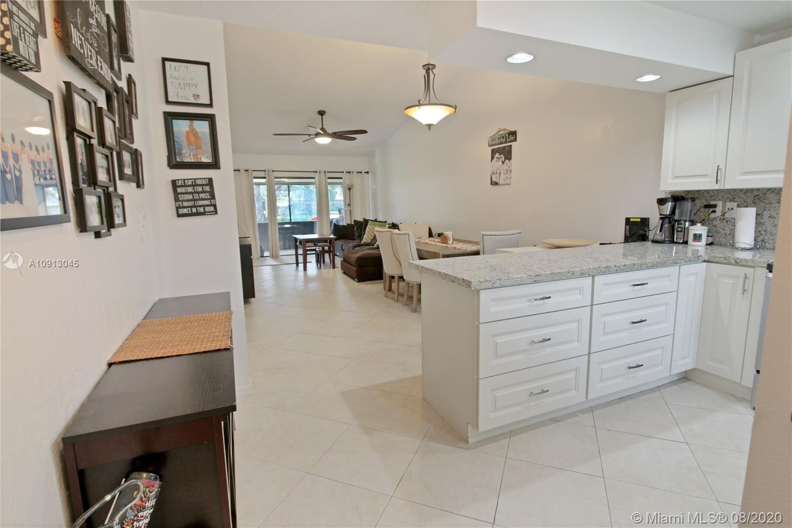 739 Banks Road Margate, FL 33063 - Photo 4 of 21 a large white kitchen with cabinets