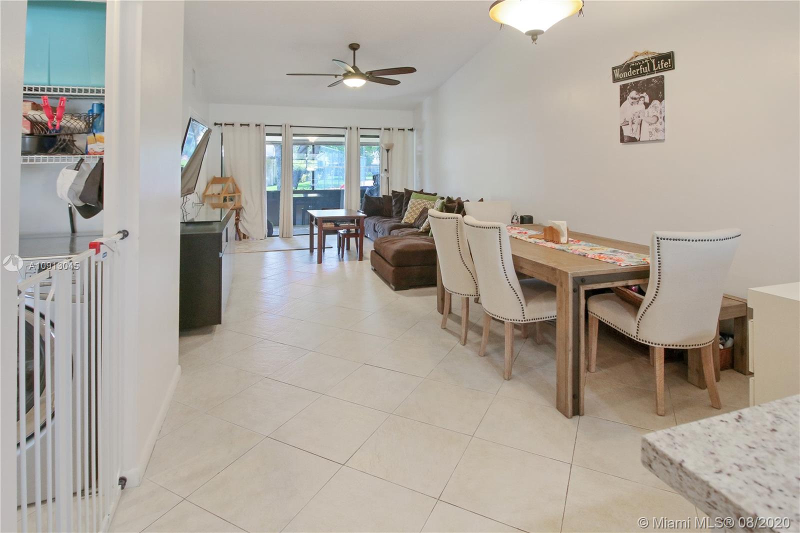 739 Banks Road Margate, FL 33063 - Photo 6 of 21 a living room with furniture a rug and white walls