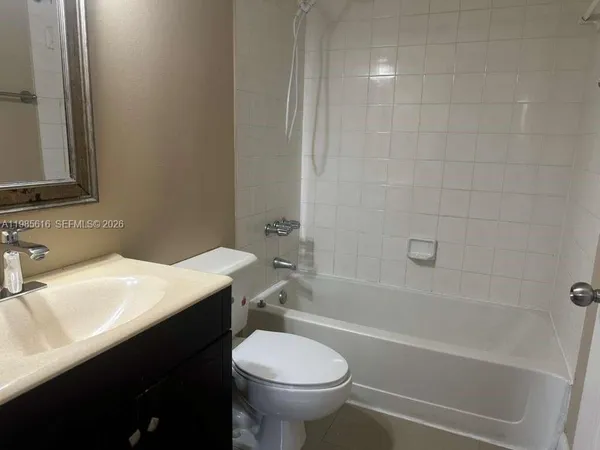a white toilet sitting next to a bathroom sink