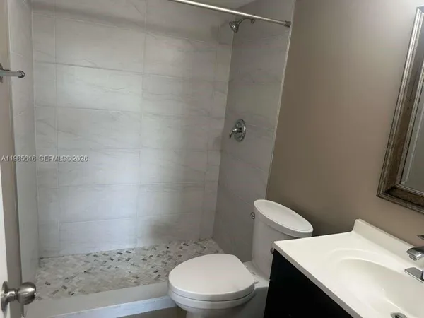 a swimming pool with outdoor seating and barbeque oven