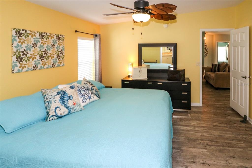 29200 South Jones Loop Road, Unit 522 Punta Gorda, FL 33950 - Photo 11 of 38 a bedroom with a bed and wooden floor