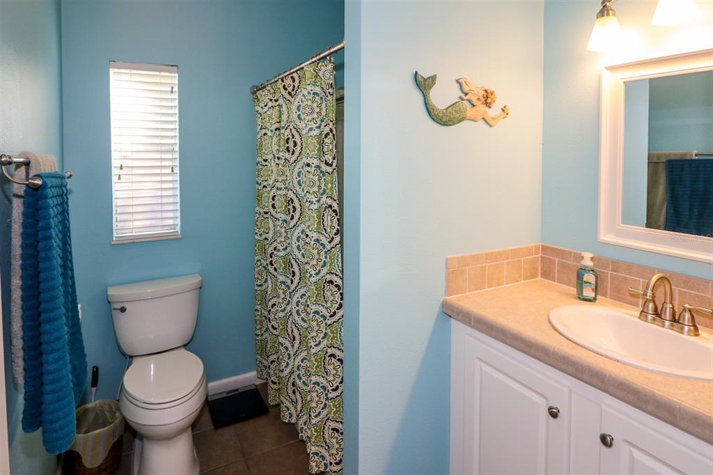 29200 South Jones Loop Road, Unit 522 Punta Gorda, FL 33950 - Photo 15 of 38 a bathroom with a granite countertop toilet and a sink