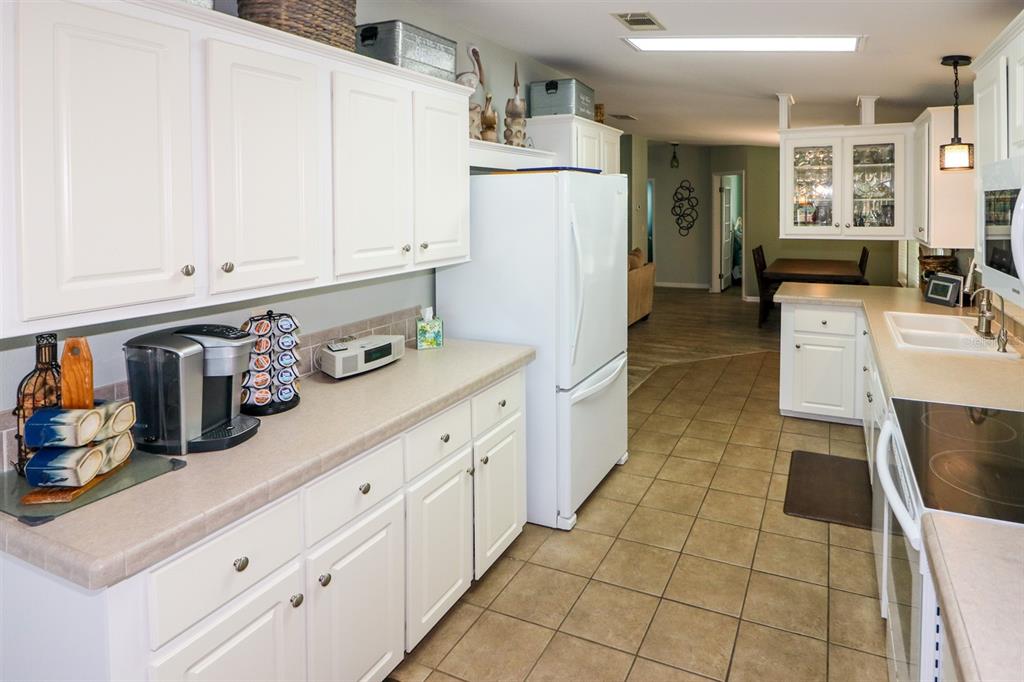 29200 South Jones Loop Road, Unit 522 Punta Gorda, FL 33950 - Photo 22 of 38 a kitchen with stainless steel appliances a refrigerator sink and cabinets