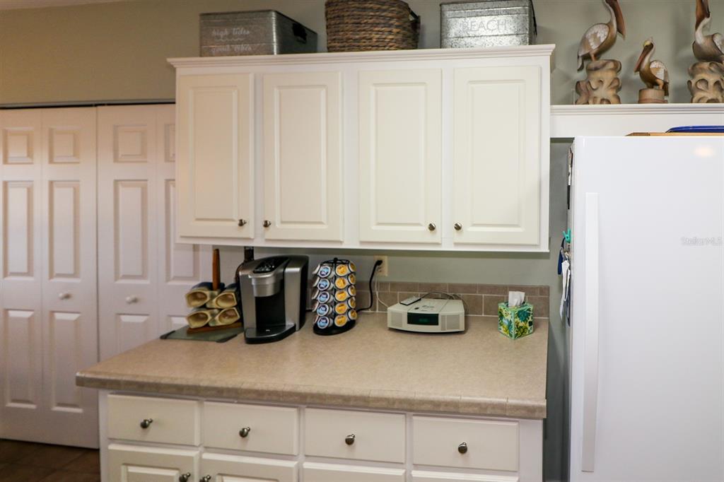 29200 South Jones Loop Road, Unit 522 Punta Gorda, FL 33950 - Photo 24 of 38 a kitchen with white cabinets and white appliances