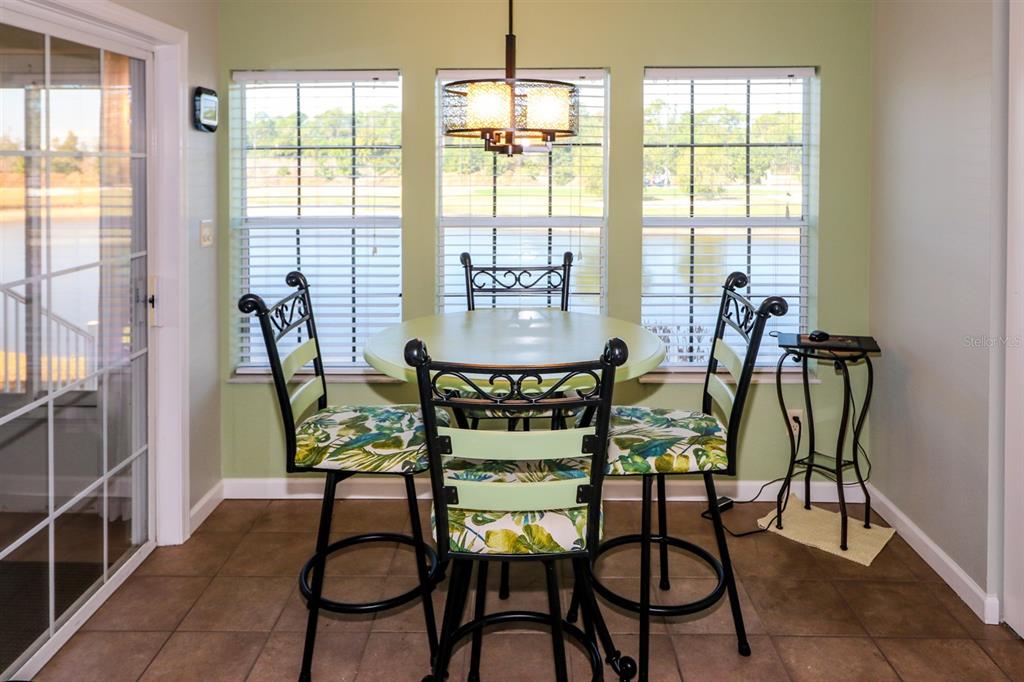29200 South Jones Loop Road, Unit 522 Punta Gorda, FL 33950 - Photo 26 of 38 a view of a dining room with furniture and a window