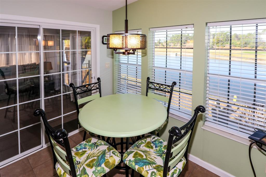 29200 South Jones Loop Road, Unit 522 Punta Gorda, FL 33950 - Photo 27 of 38 a view of a dining room with furniture and window