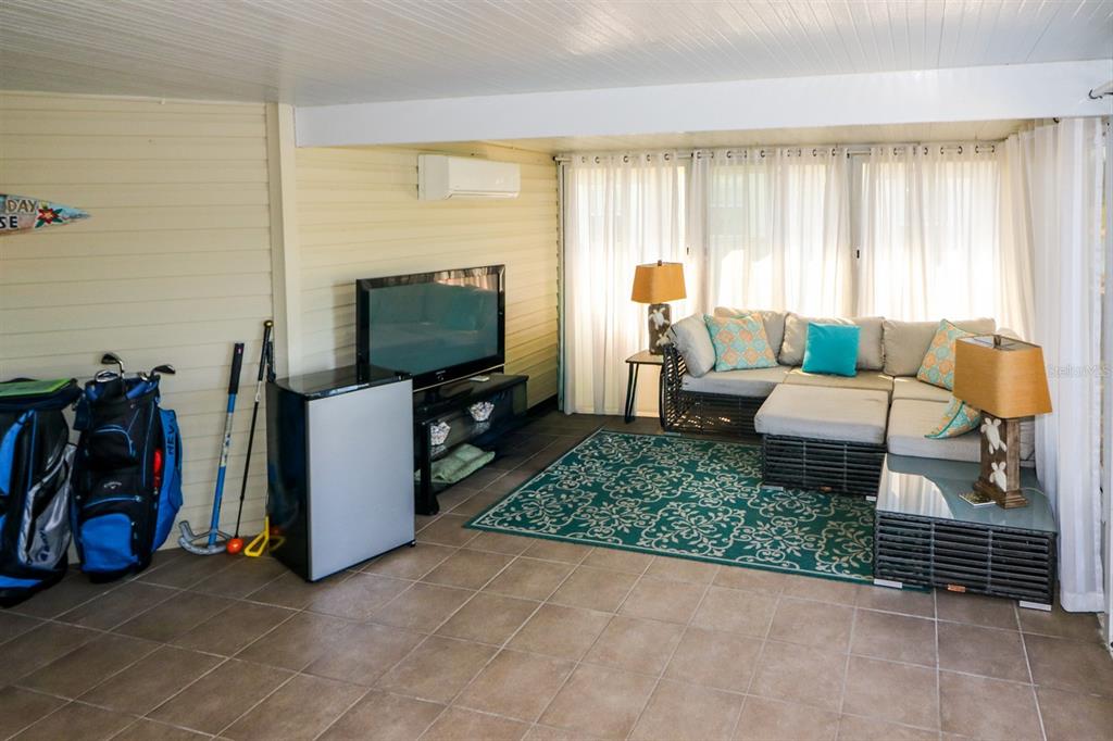 29200 South Jones Loop Road, Unit 522 Punta Gorda, FL 33950 - Photo 29 of 38 a living room with furniture and a flat screen tv