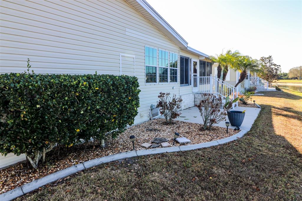 29200 South Jones Loop Road, Unit 522 Punta Gorda, FL 33950 - Photo 32 of 38 a front view of a house with a yard