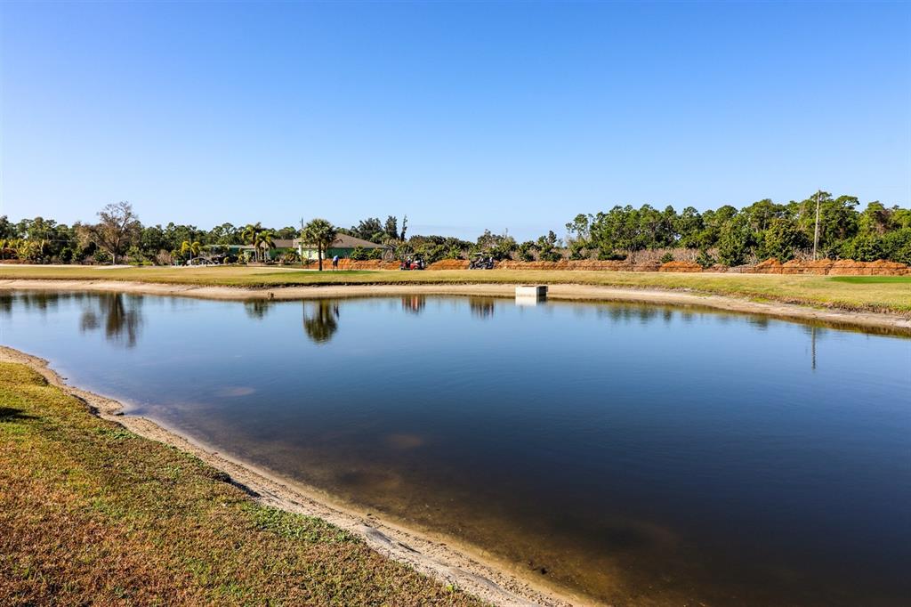29200 South Jones Loop Road, Unit 522 Punta Gorda, FL 33950 - Photo 33 of 38 a view of a lake with houses in the back