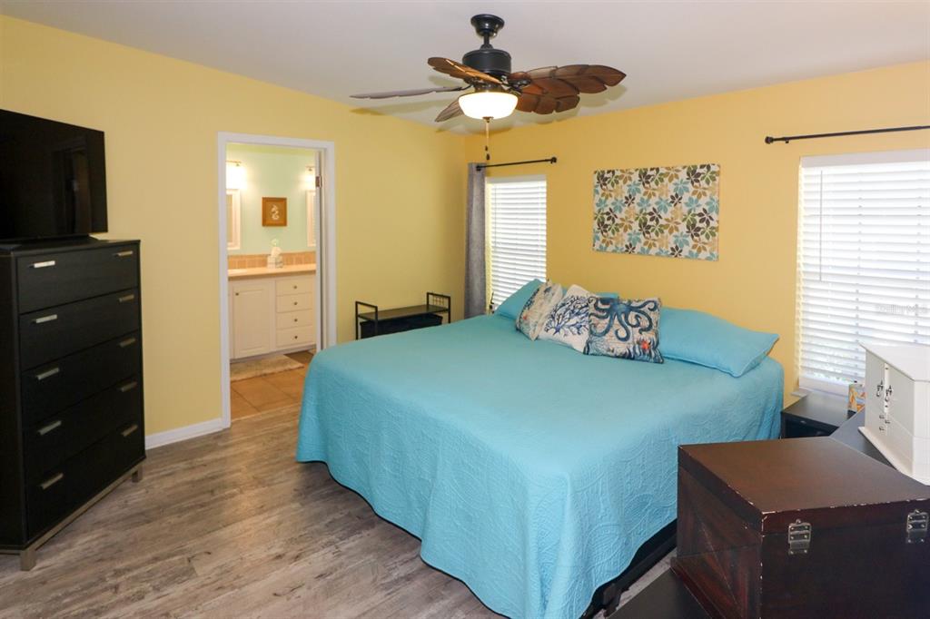 29200 South Jones Loop Road, Unit 522 Punta Gorda, FL 33950 - Photo 6 of 38 a bedroom with a bed and a flat screen tv