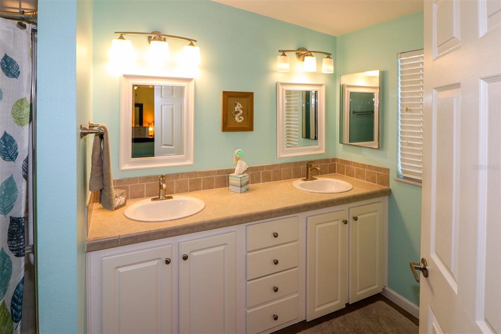 29200 South Jones Loop Road, Unit 522 Punta Gorda, FL 33950 - Photo 8 of 38 a bathroom with double sink and a mirror