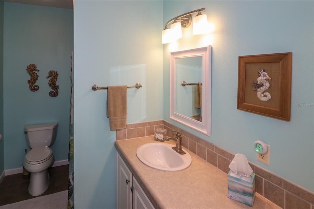 29200 South Jones Loop Road, Unit 522 Punta Gorda, FL 33950 - Photo 10 of 38 a bathroom with a toilet sink and mirror