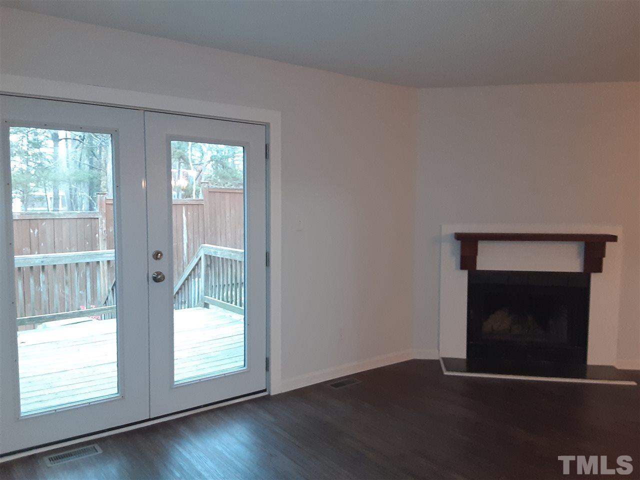 6788 Chauncey Drive Raleigh, NC 27615 - Photo 9 of 30 Wood burning fireplace. Brand new back door!