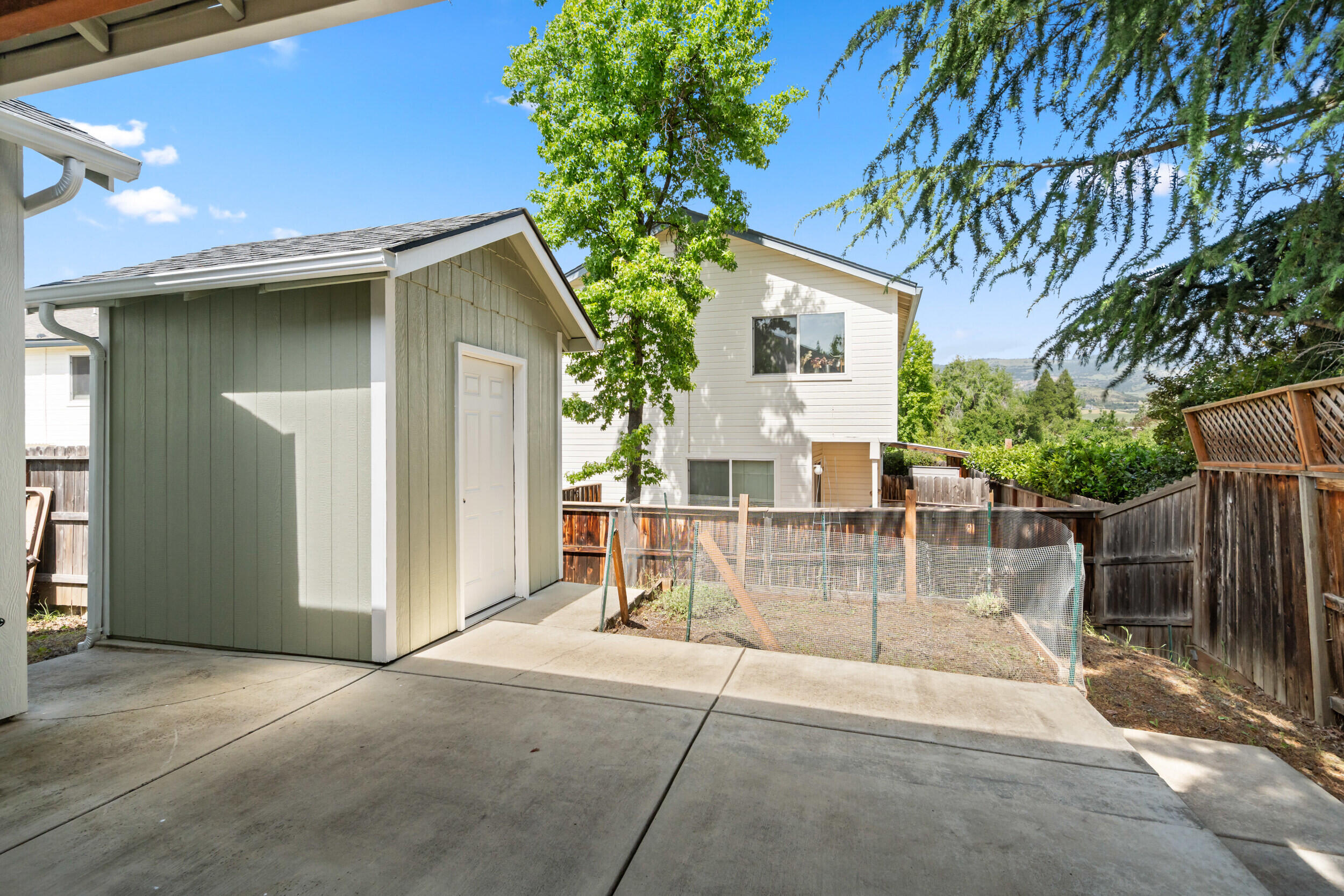 1227 Lithia Way Talent, OR 97540 - Photo 32 of 37 a view of a house with a patio and a yard