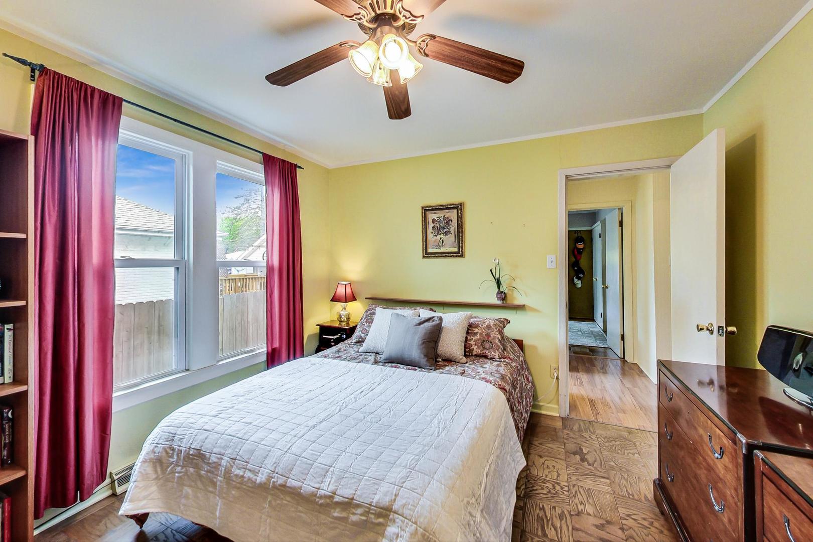 431 Selborne Road Riverside, IL 60546 - Photo 11 of 33 a bedroom with a large bed and a chandelier