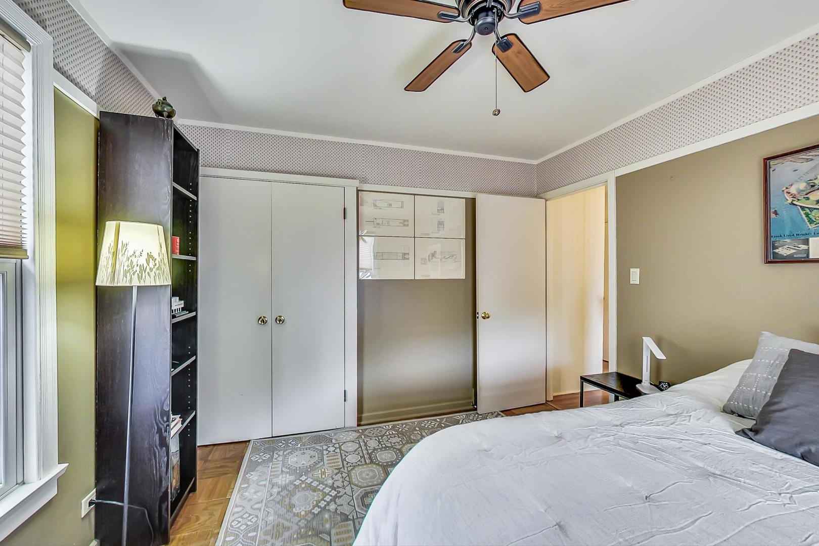 431 Selborne Road Riverside, IL 60546 - Photo 14 of 33 a bedroom with a bed and a chandelier