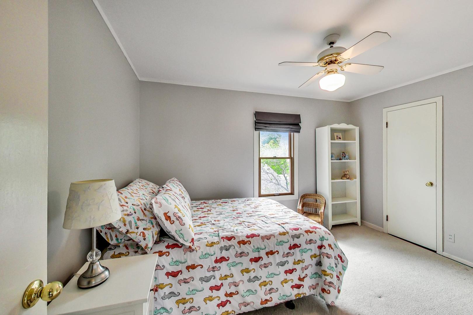 431 Selborne Road Riverside, IL 60546 - Photo 18 of 33 a bedroom with a bed and a chandelier