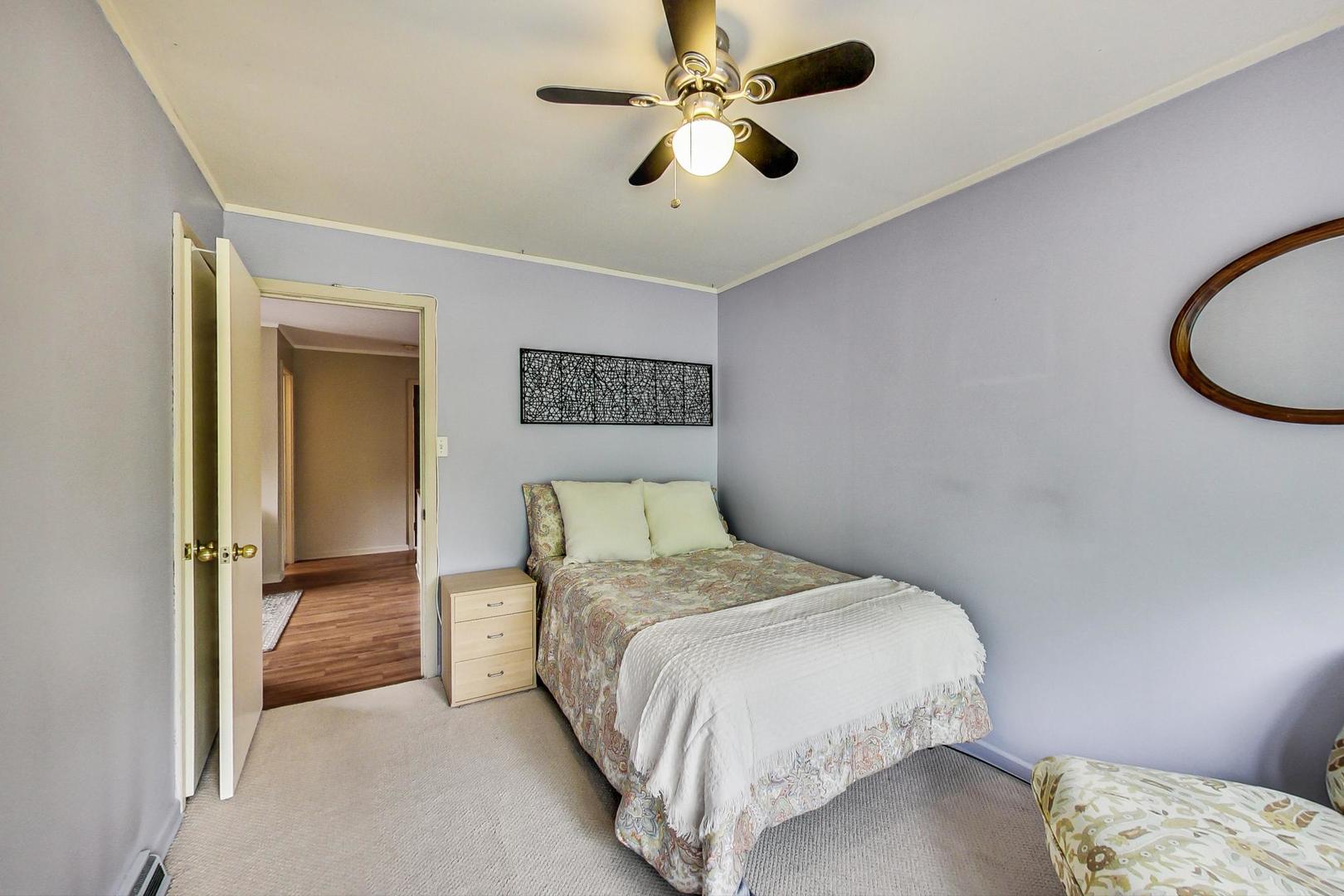 431 Selborne Road Riverside, IL 60546 - Photo 21 of 33 a bedroom with a bed and a chandelier
