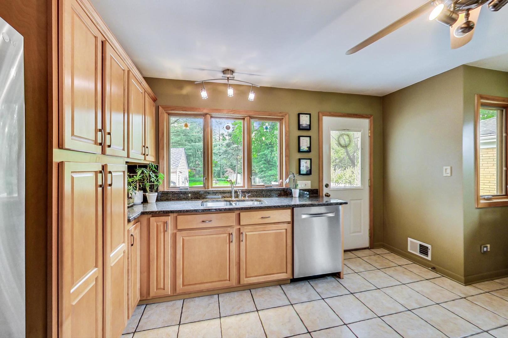 431 Selborne Road Riverside, IL 60546 - Photo 8 of 33 a kitchen with stainless steel appliances granite countertop a stove and a sink