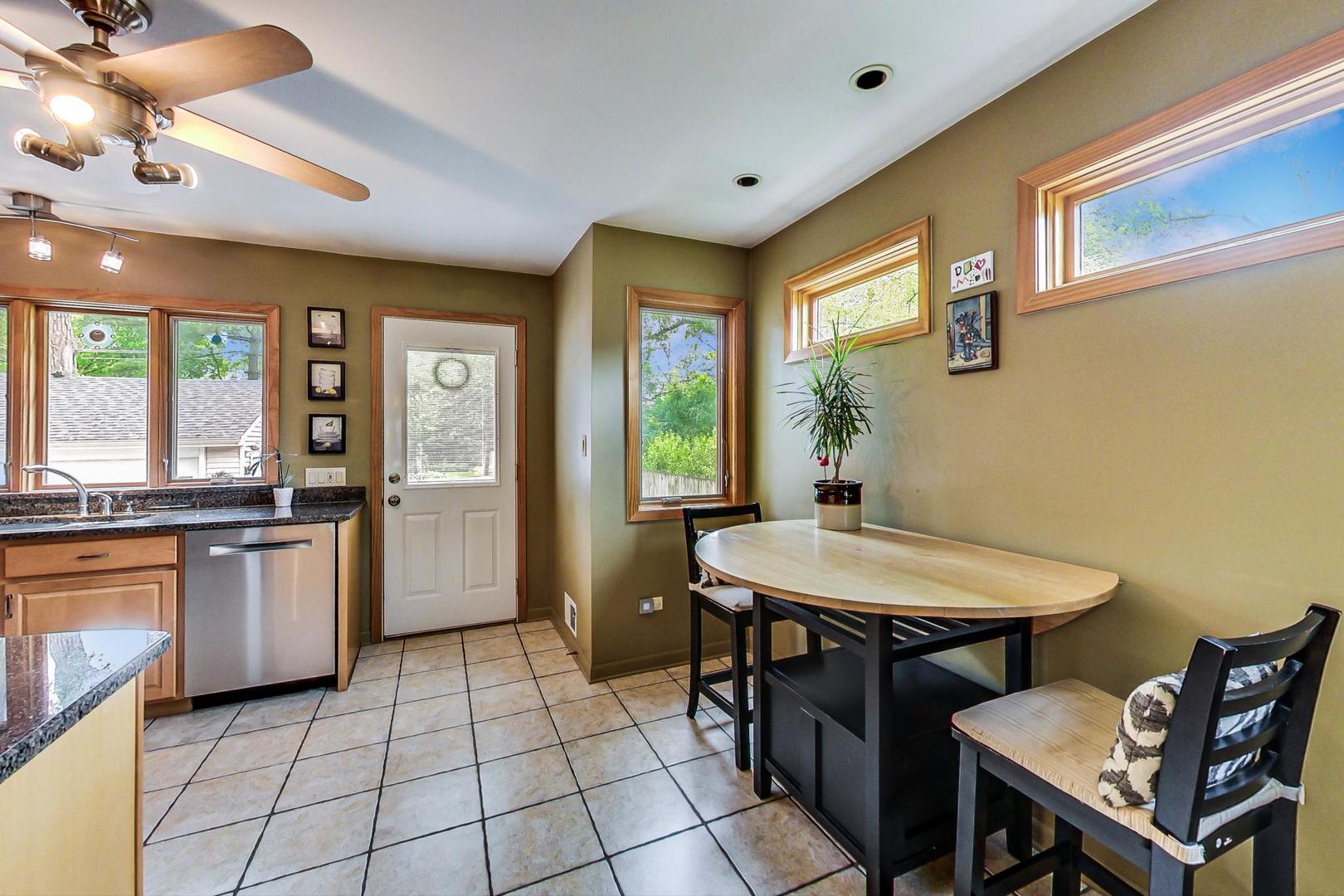 431 Selborne Road Riverside, IL 60546 - Photo 9 of 33 a kitchen with a sink dining table and chairs