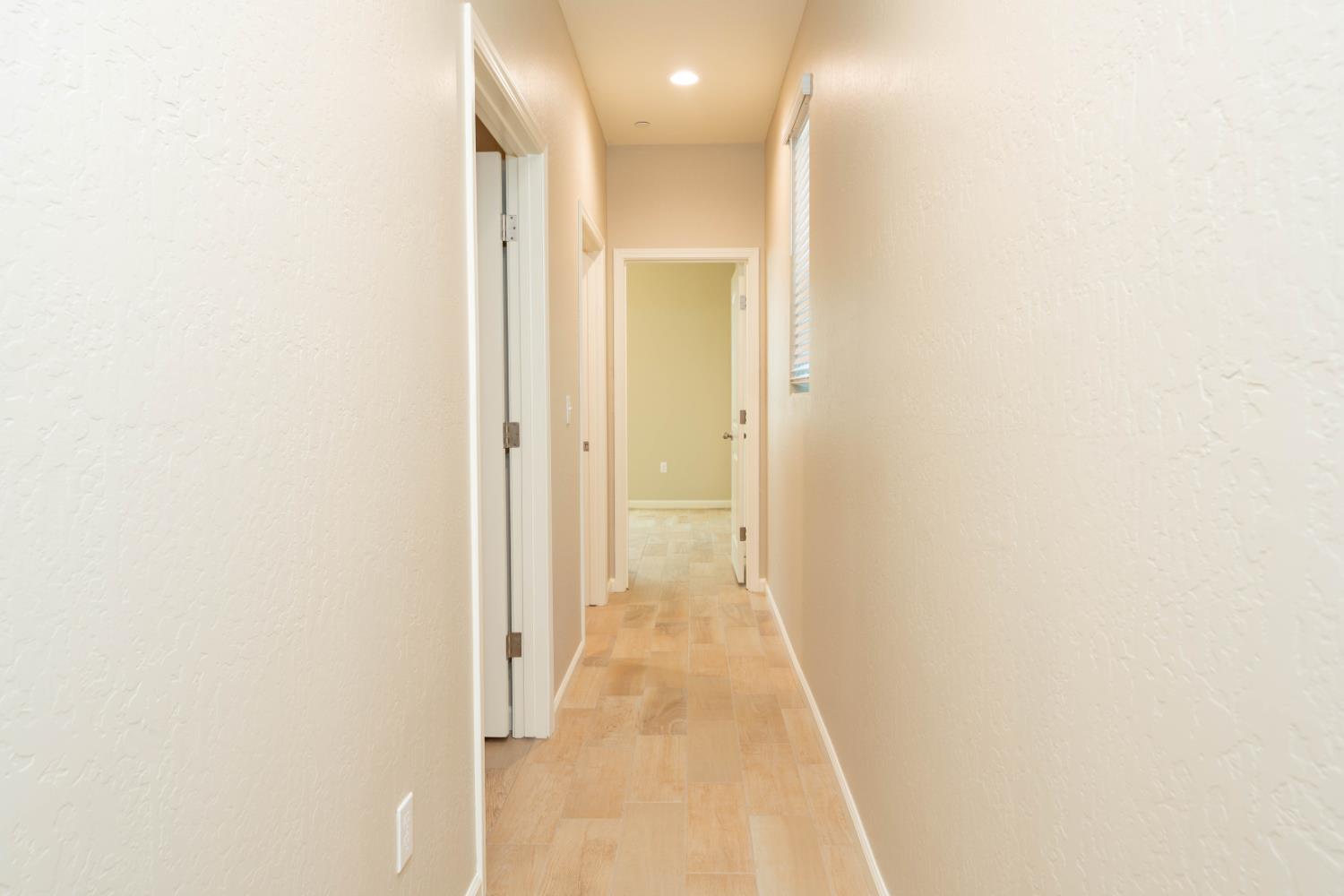 30480 Bellwood Road Visalia, CA 93291 - Photo 23 of 37 a view of a hallway with wooden floor