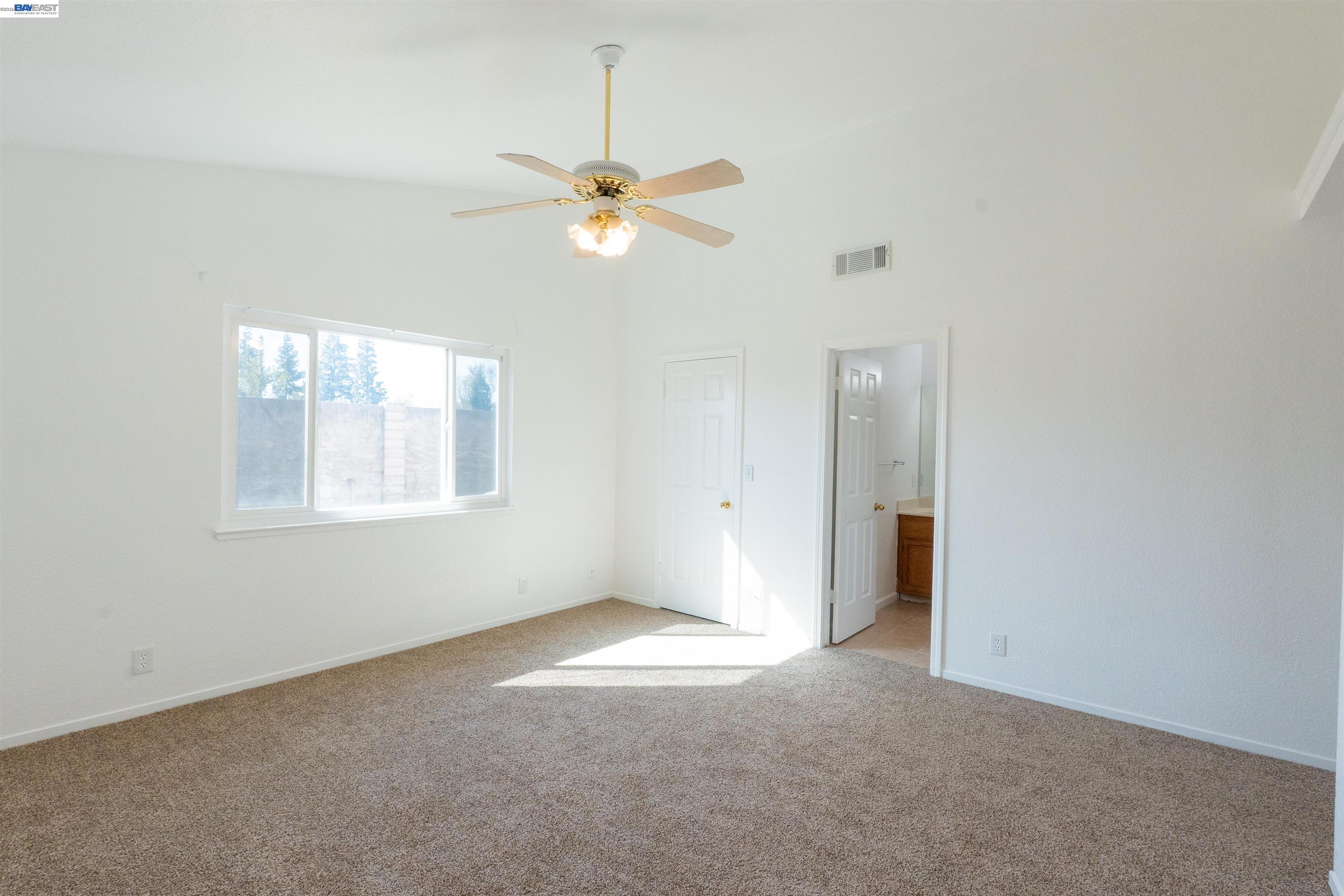 2932 Alcott Court Modesto, CA 95355 - Photo 11 of 39 an empty room with windows and fan
