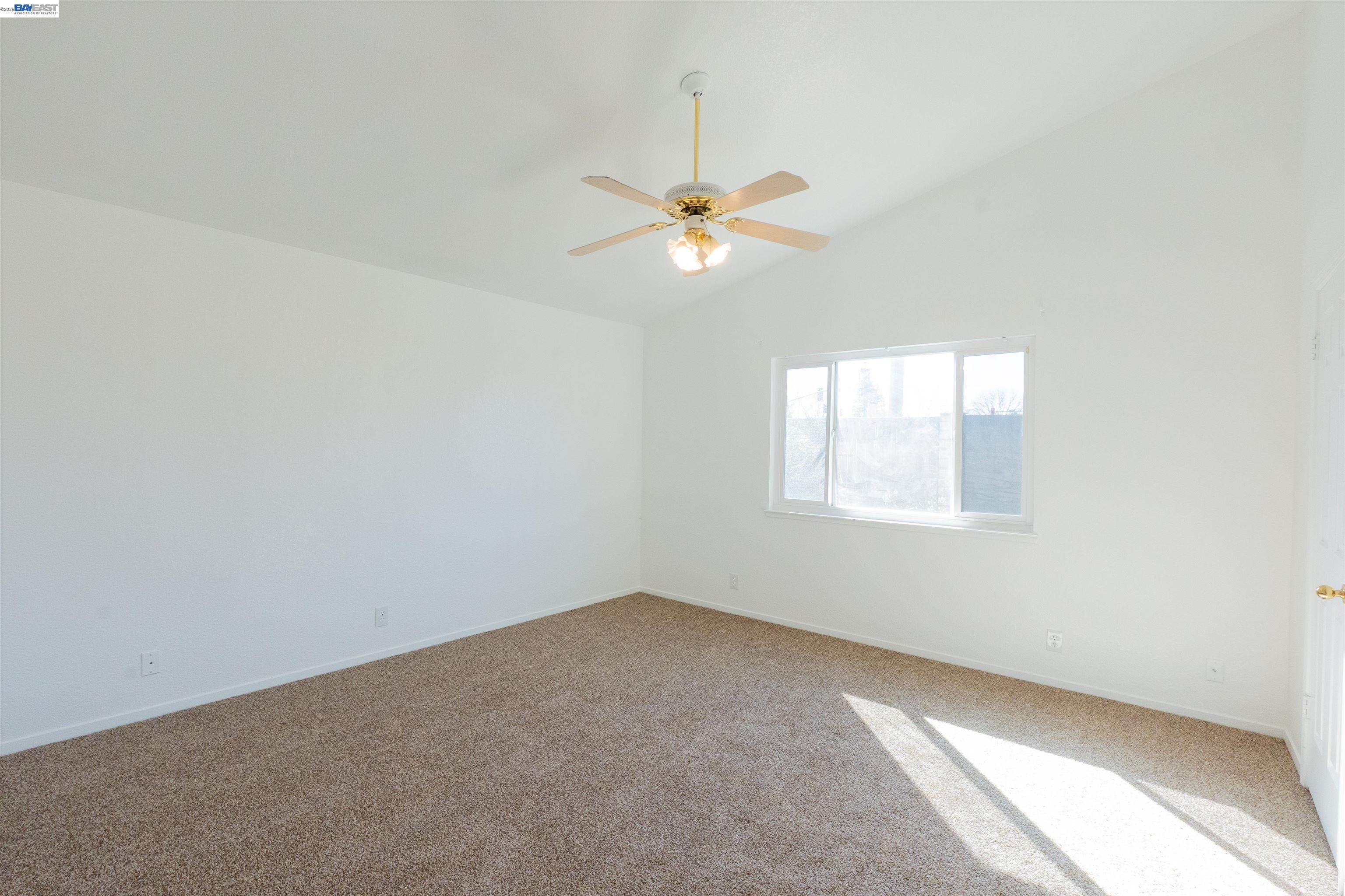 2932 Alcott Court Modesto, CA 95355 - Photo 12 of 39 an empty room with a window and a fan