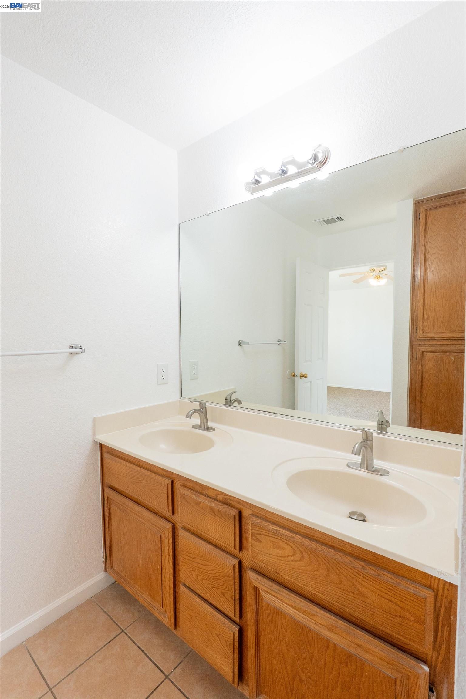2932 Alcott Court Modesto, CA 95355 - Photo 13 of 39 a bathroom with a sink and a mirror