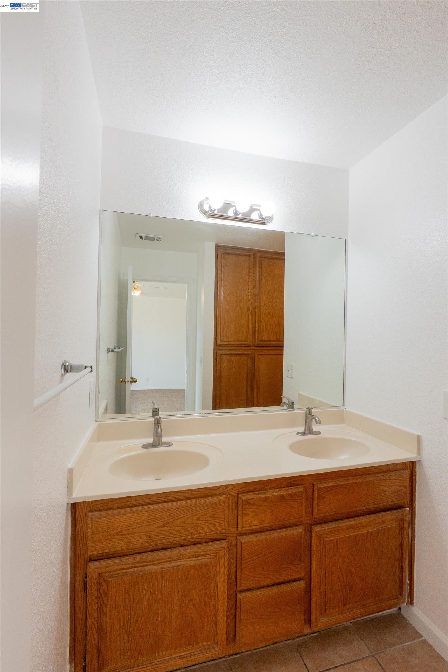 2932 Alcott Court Modesto, CA 95355 - Photo 15 of 39 a bathroom with a sink and a mirror
