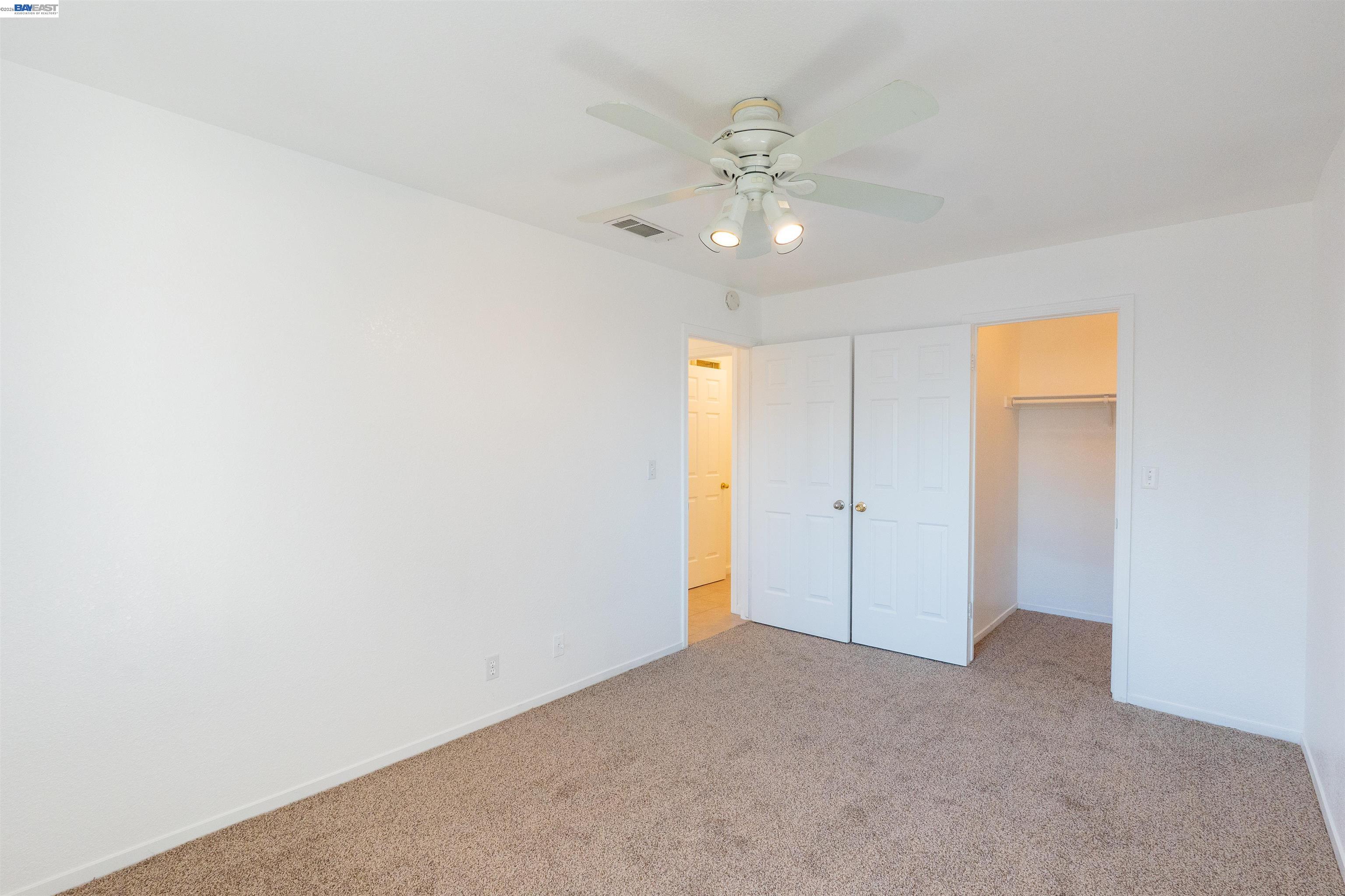 2932 Alcott Court Modesto, CA 95355 - Photo 24 of 39 a view of an empty room with a chandelier fan