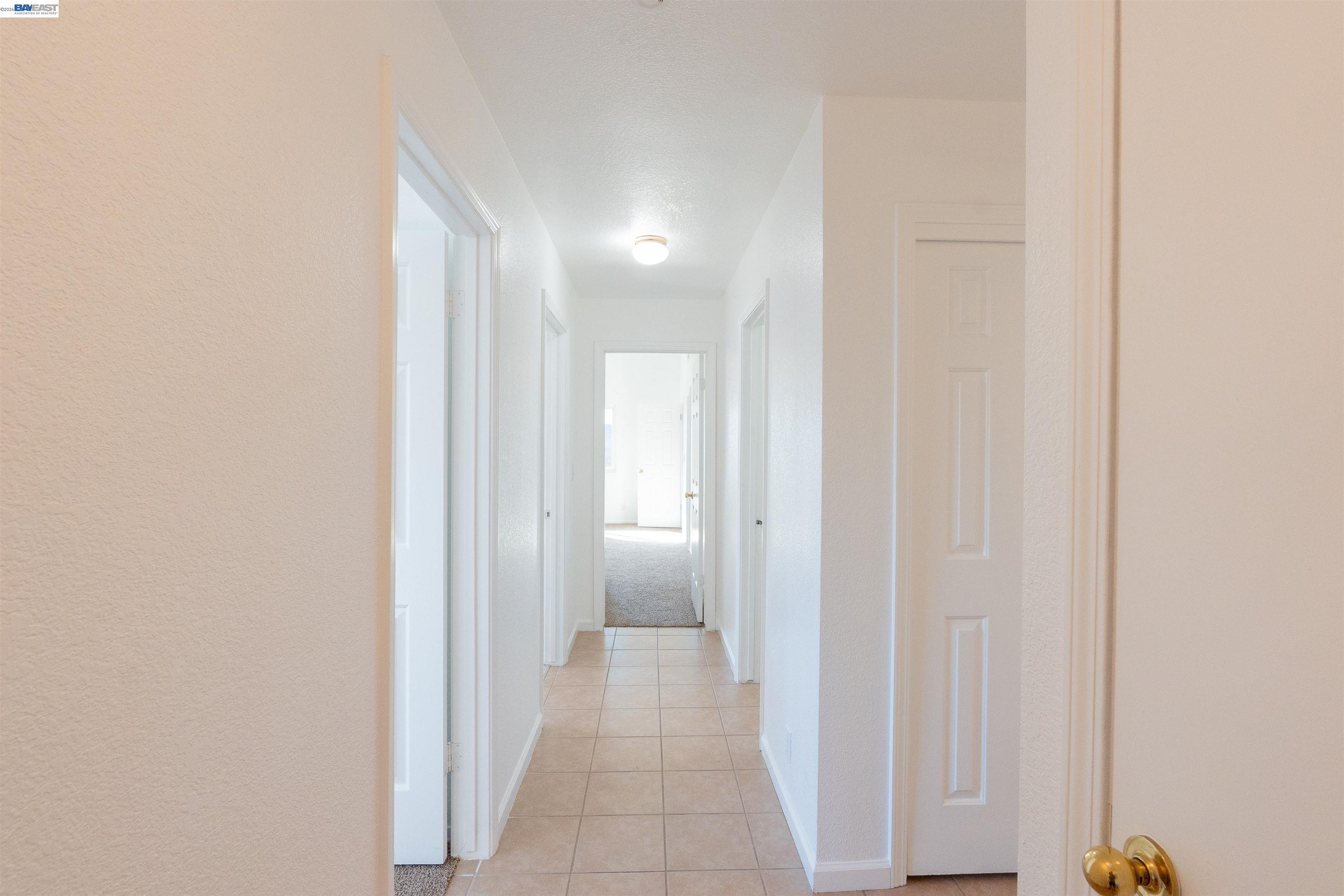 2932 Alcott Court Modesto, CA 95355 - Photo 26 of 39 a view of a hallway with a white walls