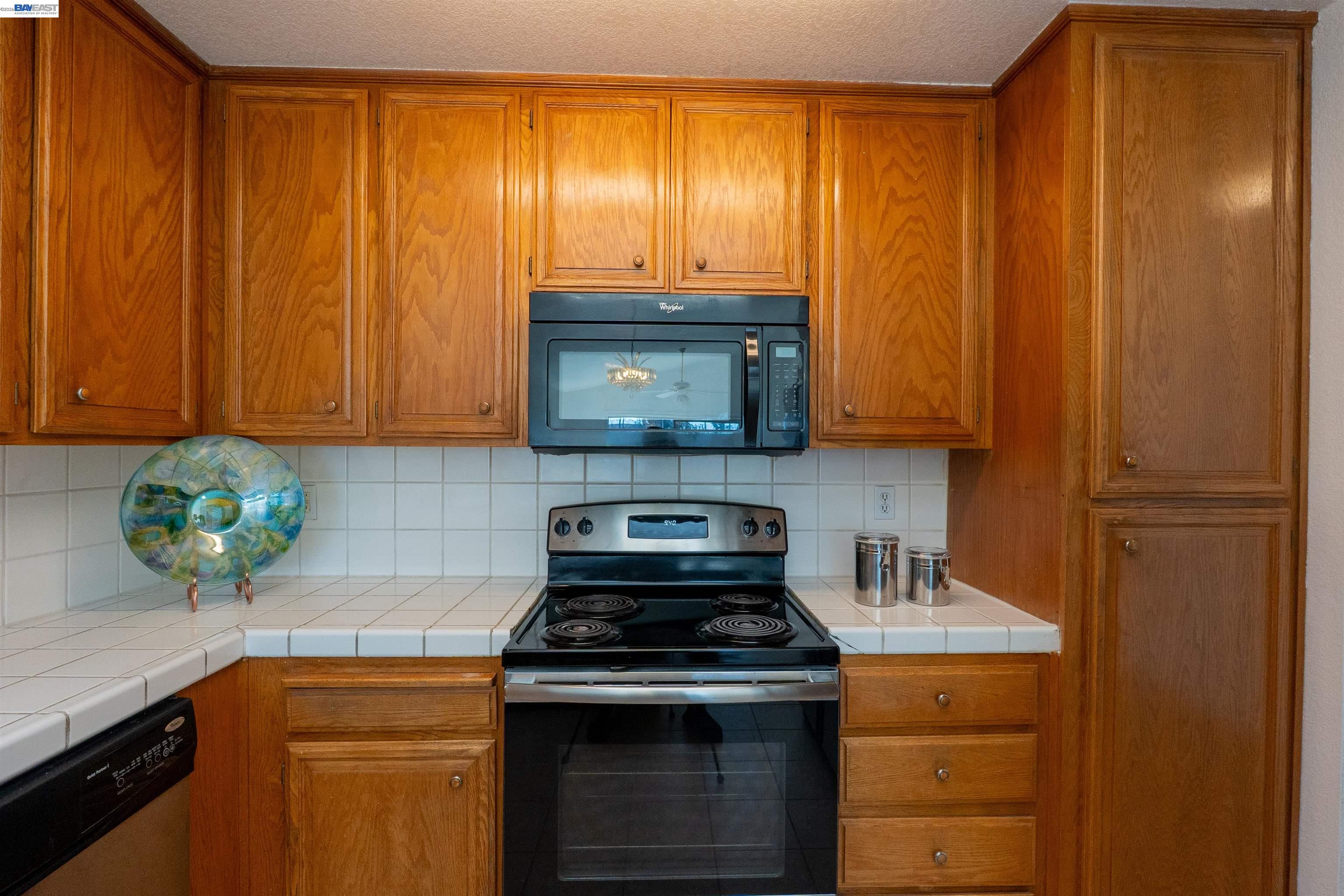 2932 Alcott Court Modesto, CA 95355 - Photo 29 of 39 a kitchen with granite countertop wood cabinets and stainless steel appliances