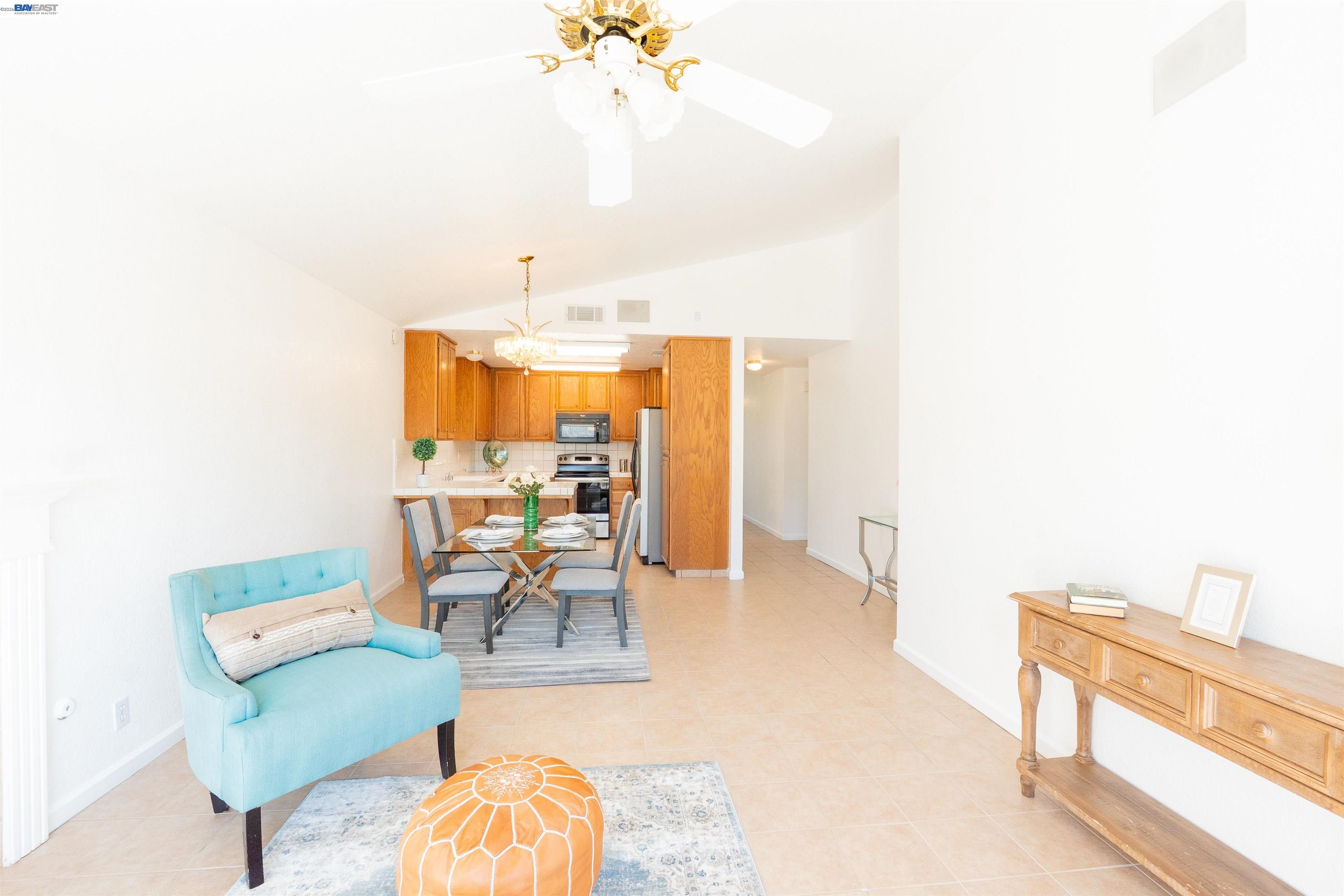 2932 Alcott Court Modesto, CA 95355 - Photo 33 of 39 a living room with furniture and a chandelier