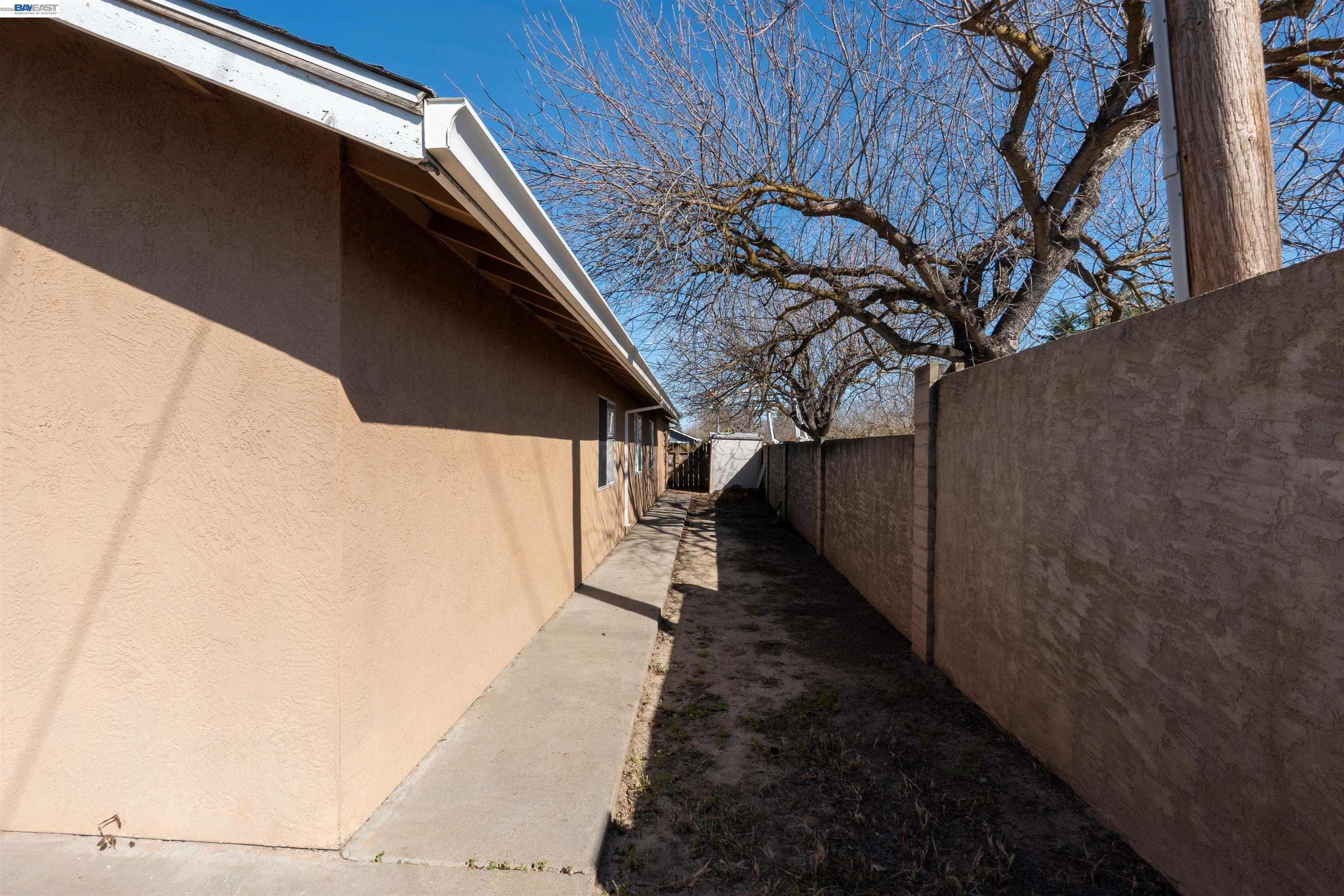 2932 Alcott Court Modesto, CA 95355 - Photo 4 of 39 a view of a pathway of a house with wooden fence