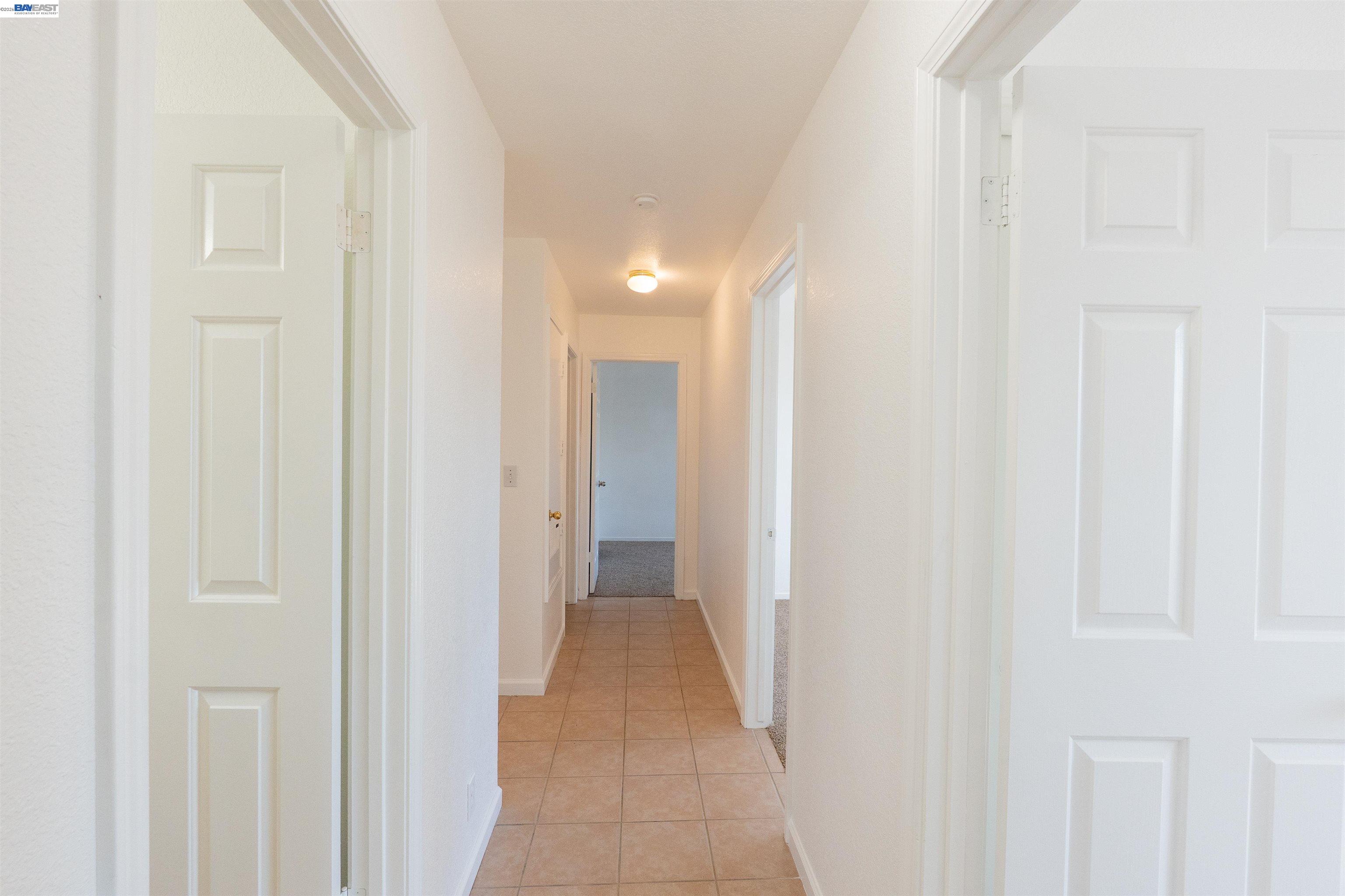 2932 Alcott Court Modesto, CA 95355 - Photo 8 of 39 a view of a hallway with wooden floor