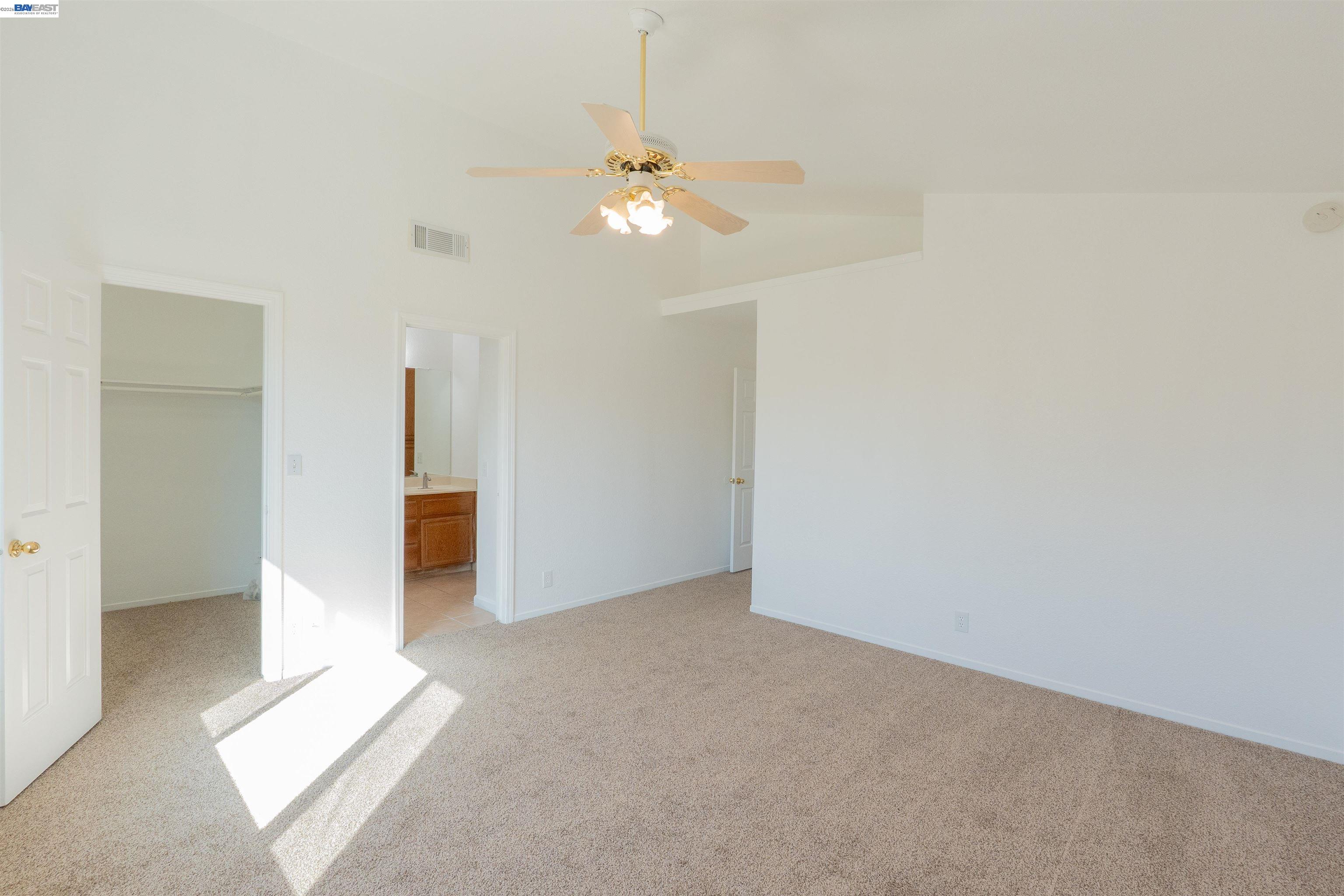 2932 Alcott Court Modesto, CA 95355 - Photo 9 of 39 an empty room with closet and a chandelier fan