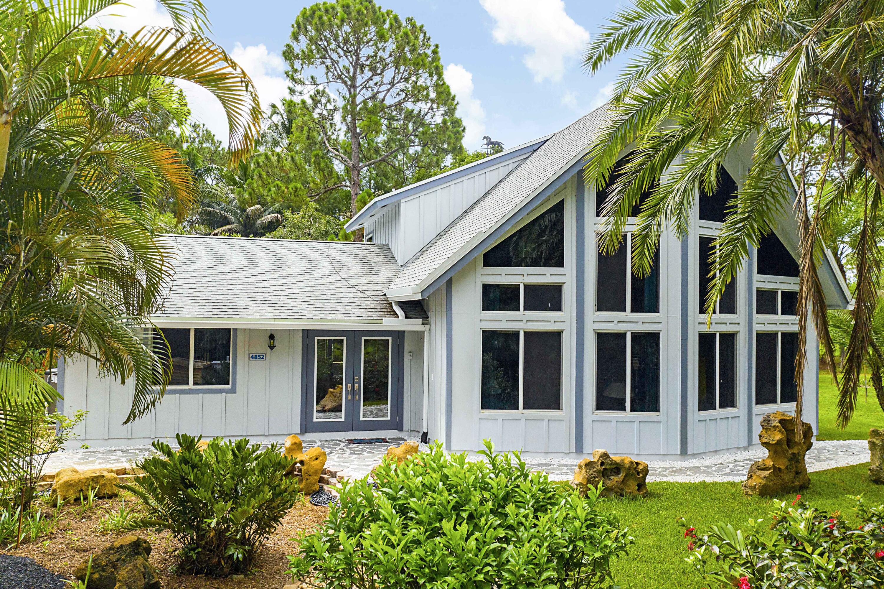 a front view of a house with a garden