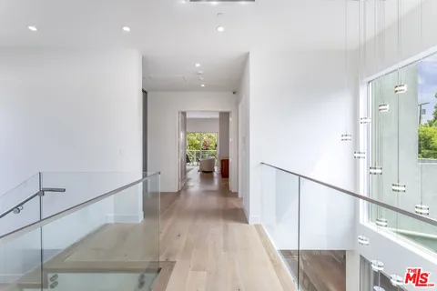 a view of a hallway view with wooden floor and staircase