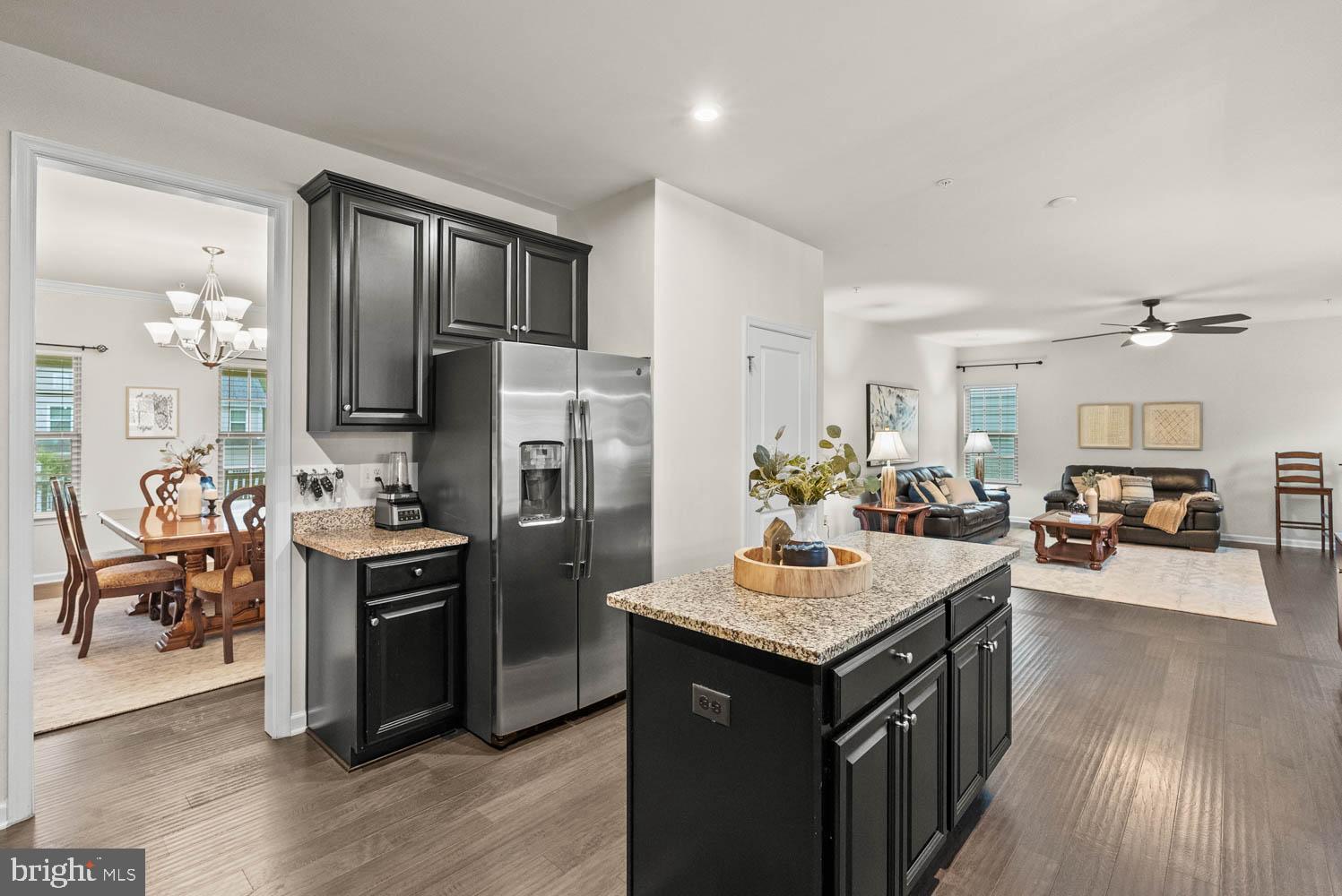 17883 Sugarberry Road Dumfries, VA 22026 - Photo 18 of 53 a kitchen with kitchen island a counter top space a sink appliances and cabinets