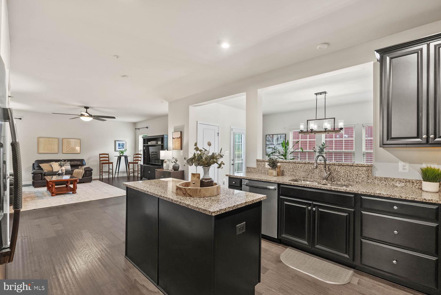 17883 Sugarberry Road Dumfries, VA 22026 - Photo 20 of 53 a kitchen with a sink stove and wooden cabinets