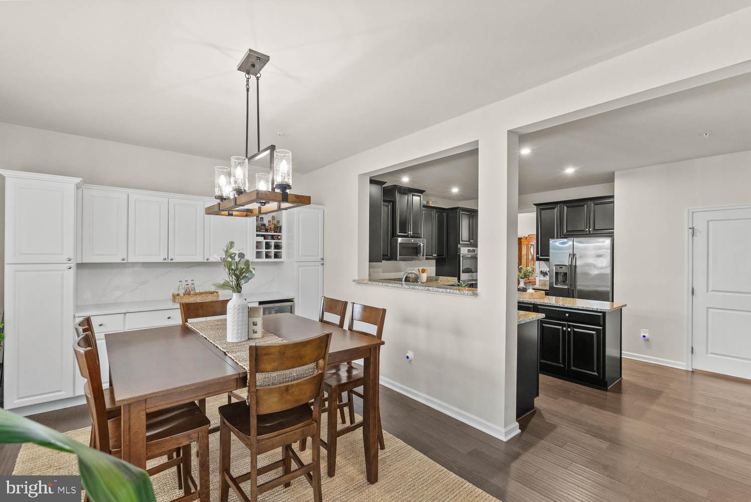 17883 Sugarberry Road Dumfries, VA 22026 - Photo 22 of 53 a view of a dining room and livingroom with furniture wooden floor a chandelier