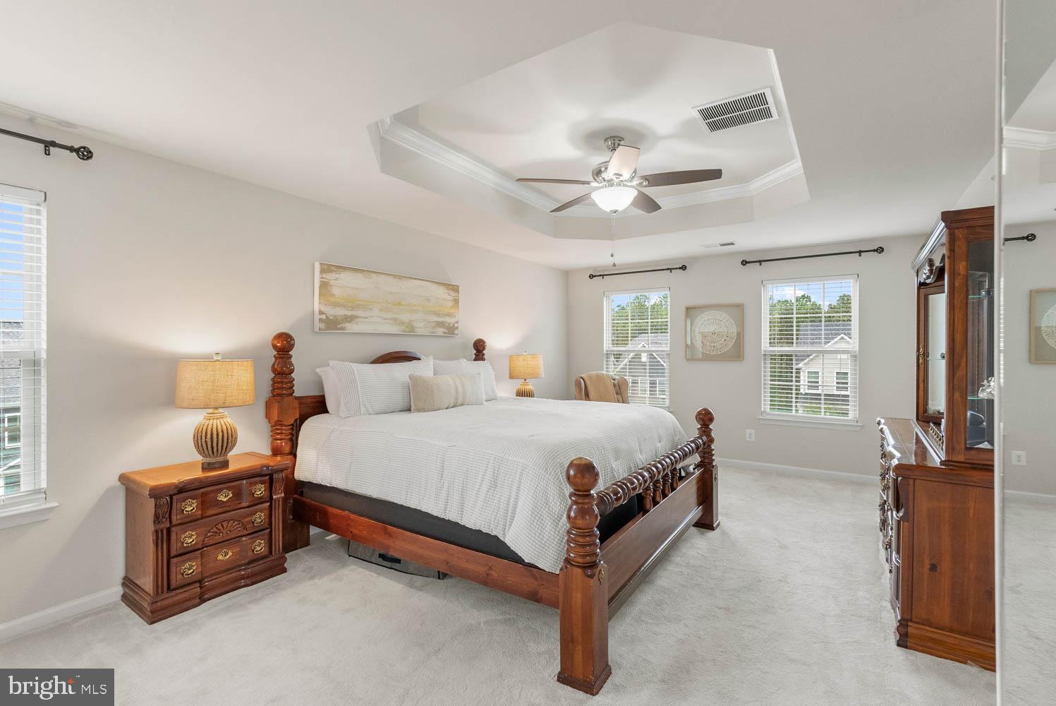 17883 Sugarberry Road Dumfries, VA 22026 - Photo 28 of 53 a spacious bedroom with a bed and a chandelier