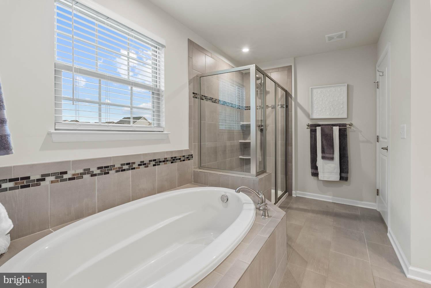 17883 Sugarberry Road Dumfries, VA 22026 - Photo 30 of 53 a bathroom with a bathtub and a shower