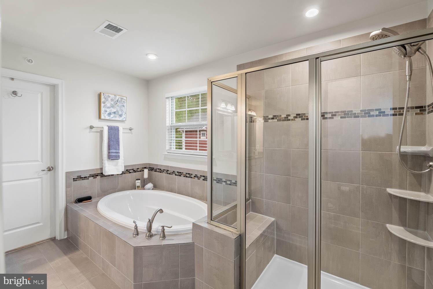 17883 Sugarberry Road Dumfries, VA 22026 - Photo 31 of 53 a white bath tub sitting next to a shower